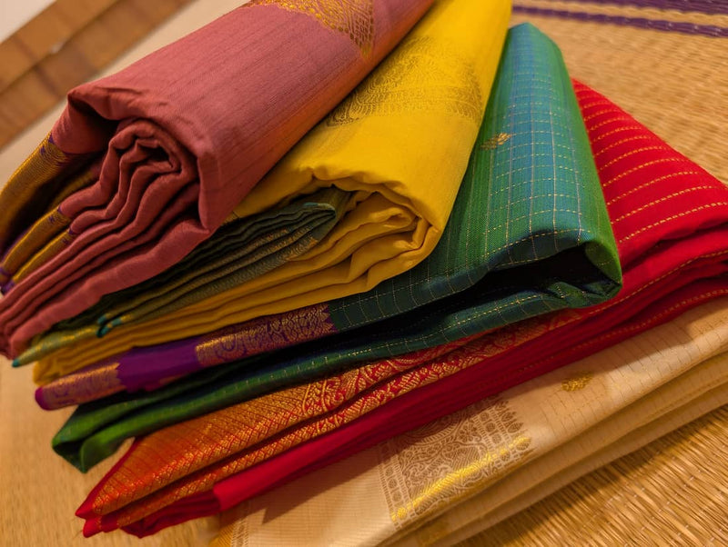 a stack of bridal kanjivaram pure silk handloom wedding sarees