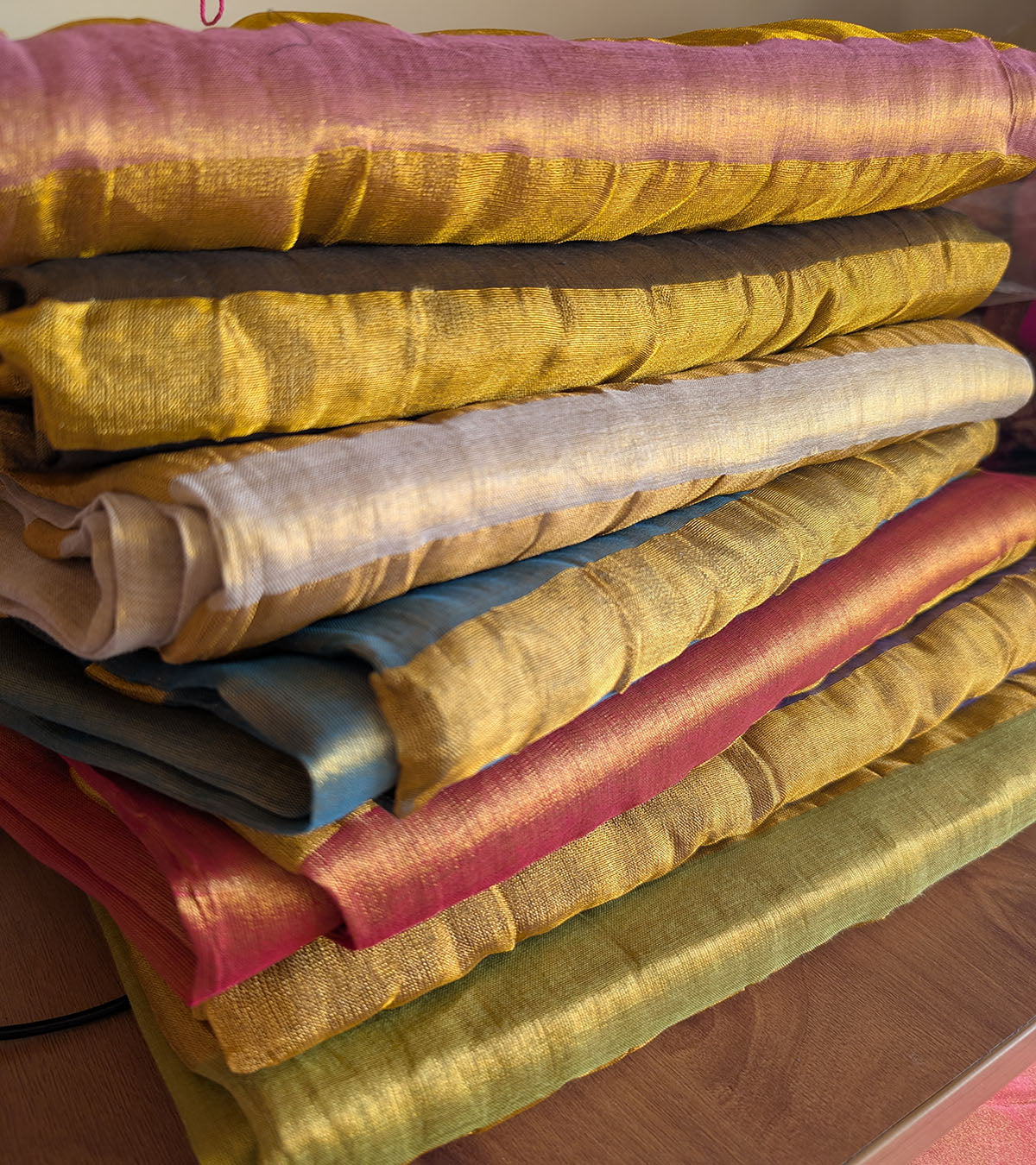 Stack of bengal tissue linen sarees with heavy pom poms