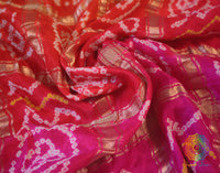 Close up of Bandhani work on Pink Orange Gajji silk Gharchola saree