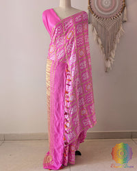 Baby pink Gharchola pure gaji silk Bandhani saree on mannequin with zari checks and Bandhani motifs
