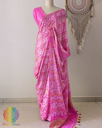 Baby pink gaji silk Gharchola saree showcasing elegant drape and traditional Bandhani design