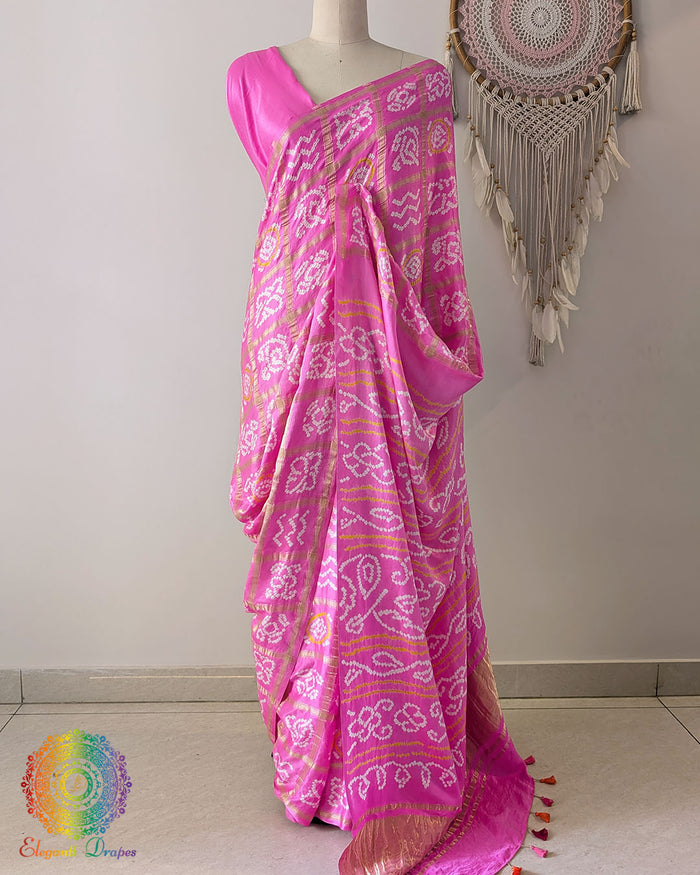 Baby pink gaji silk Gharchola saree showcasing elegant drape and traditional Bandhani design