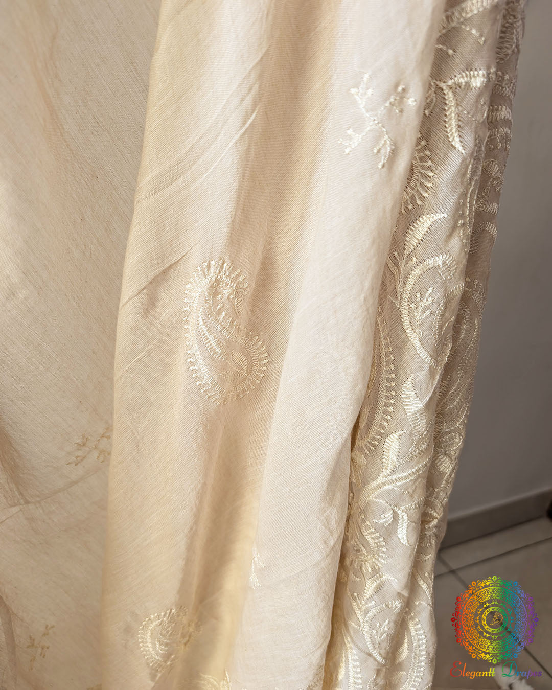Close up of delicate thread embroidery on beige Bengal cotton saree