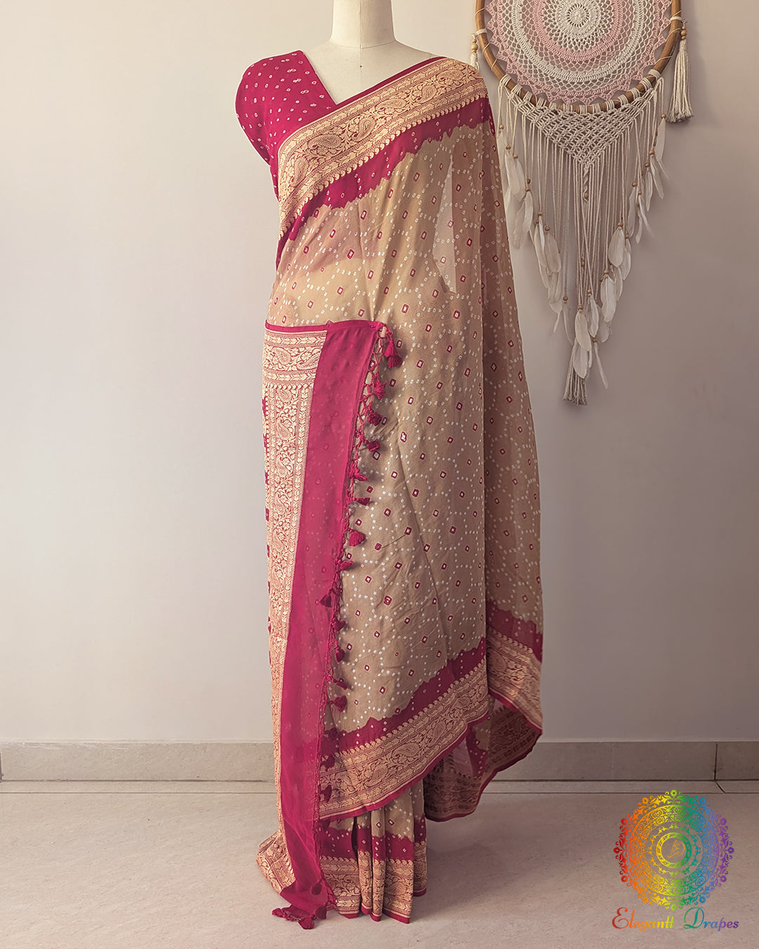 Beige Banarasi bandhani saree on mannequin showcasing red border detail