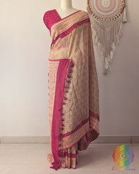Beige Banarasi bandhani saree on mannequin showcasing red border detail