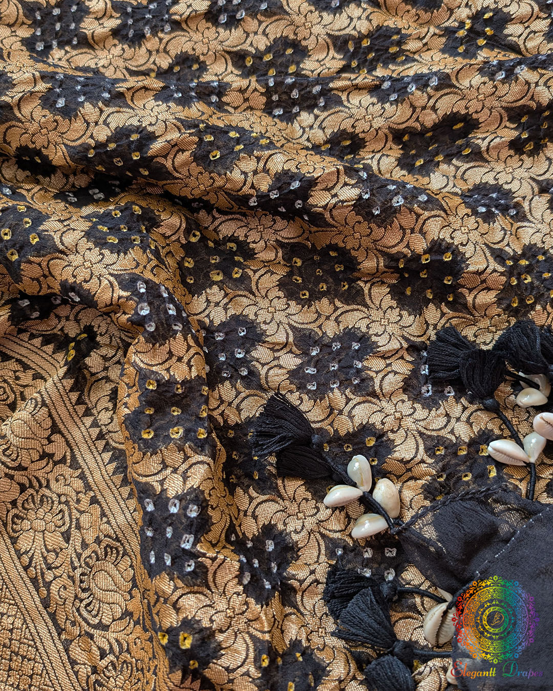 Close-up of traditional kodi tassels, zari border, and Bandhani motifs on black Banarasi georgette Gharchola dupatta