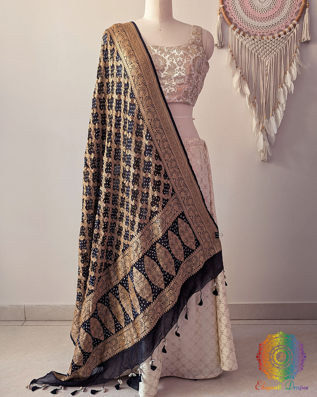 Black Banarasi georgette Gharchola Bandhani dupatta draped on mannequin with zari border and kodi tassels