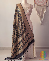 Black Banarasi georgette Gharchola Bandhani dupatta draped on mannequin with zari border and kodi tassels