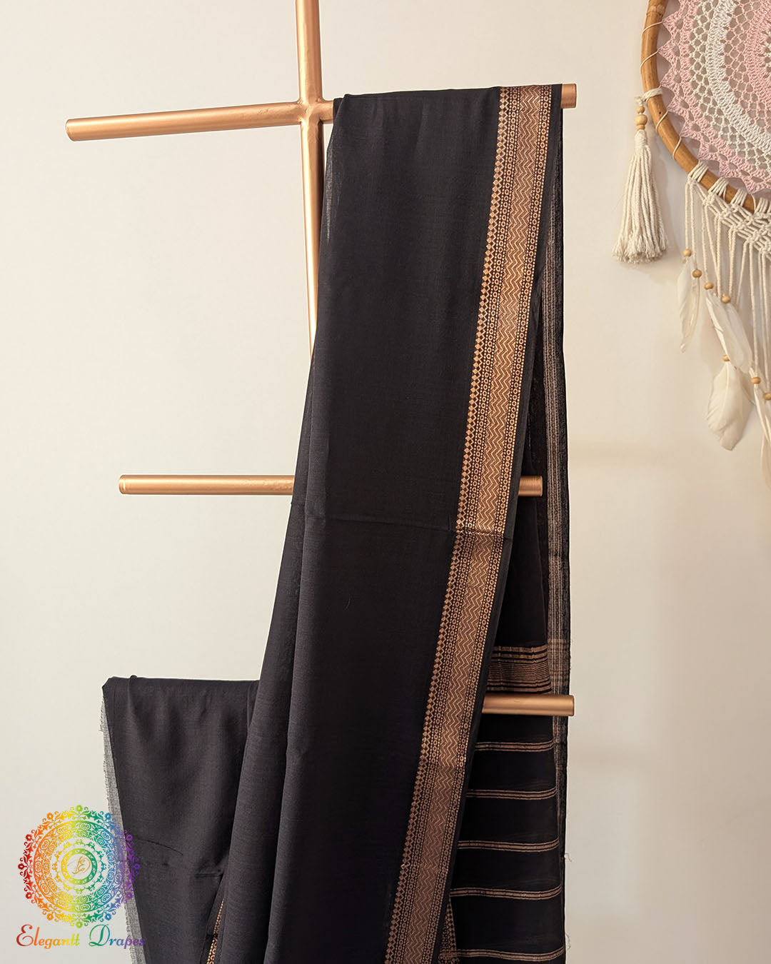 Black Bengal cotton saree body close up highlighting fabric texture with zari border detail