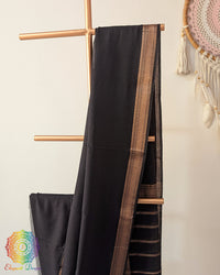 Black Bengal cotton saree body close up highlighting fabric texture with zari border detail