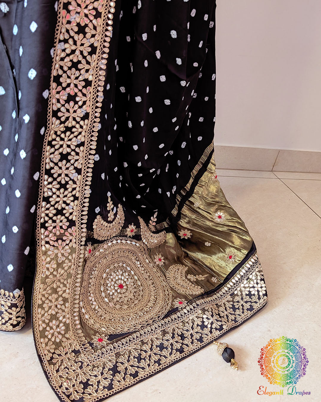 Close up of black bandhani gaji silk saree highlighting marodi and gota patti handwork