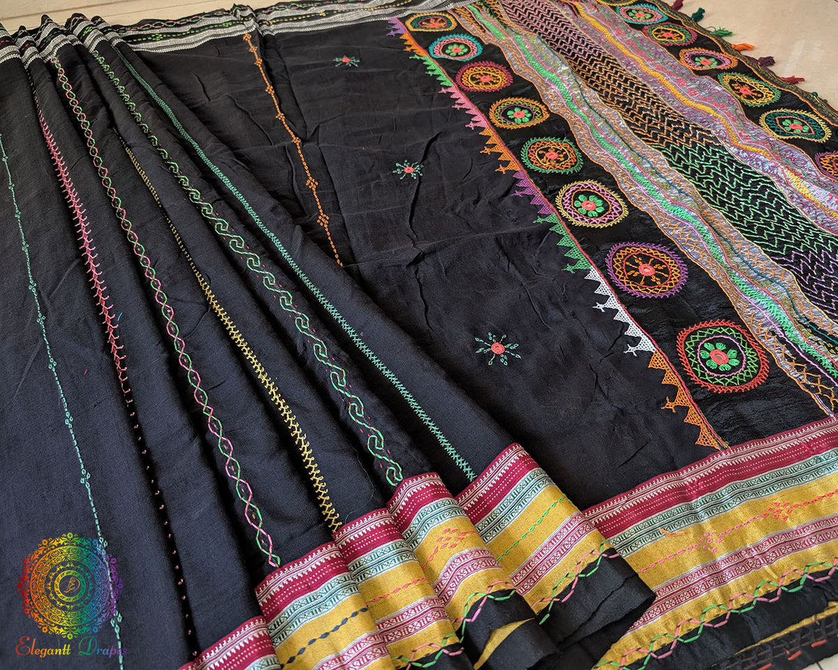 Close-up of Lambani embroidered bels and floral motifs on the black Ilkal cotton saree
