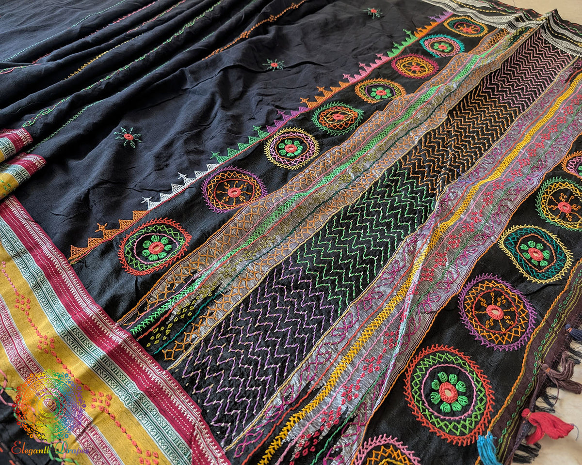 Detailed view of handcrafted Lambani embroidery on the black Ilkal cotton saree