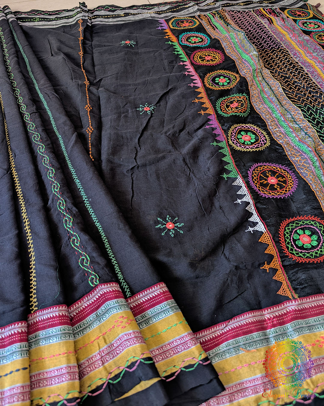 Black Ilkal cotton fabric showcasing woven texture and handcrafted embroidery