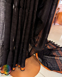 Pleats detail of black linen saree showing texture and fall