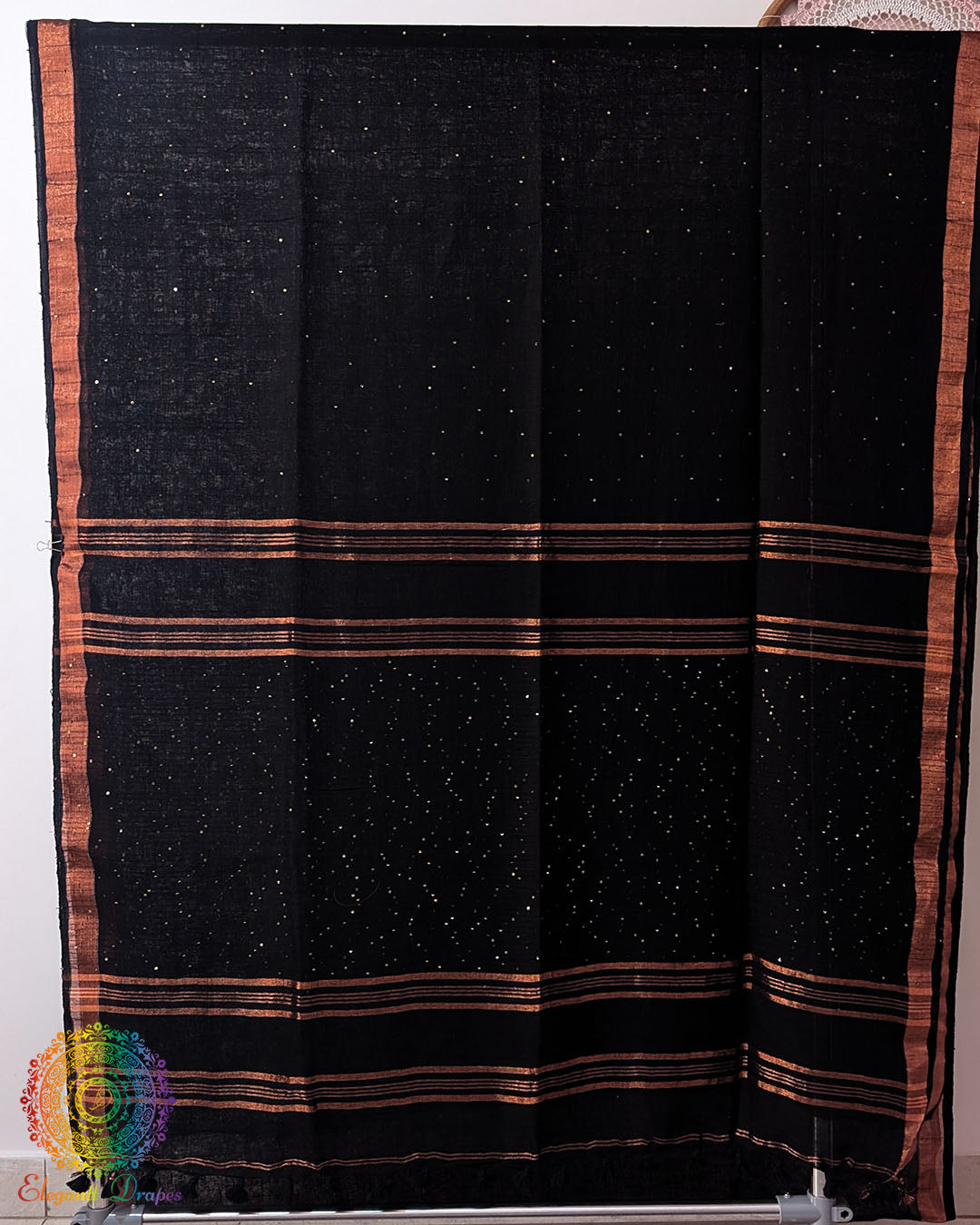 Full black linen saree laid open showing overall design and layout