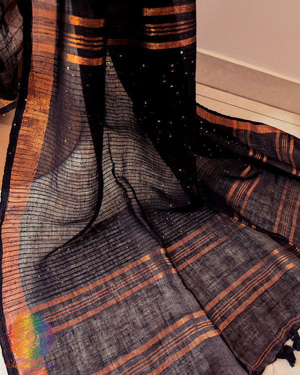 Sequin detail close up on black linen saree highlighting subtle shimmer