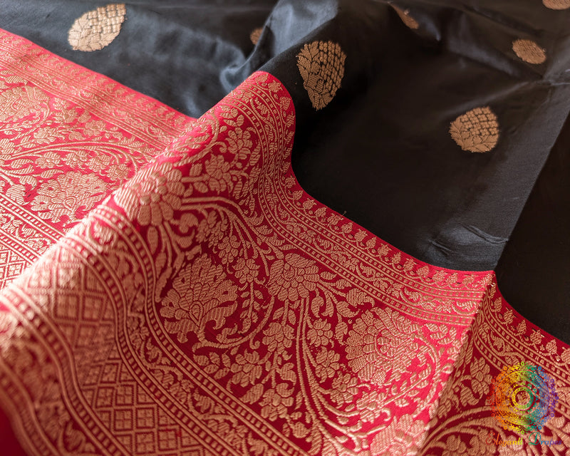Red border close up on black Banarasi handloom silk saree highlighting woven detail