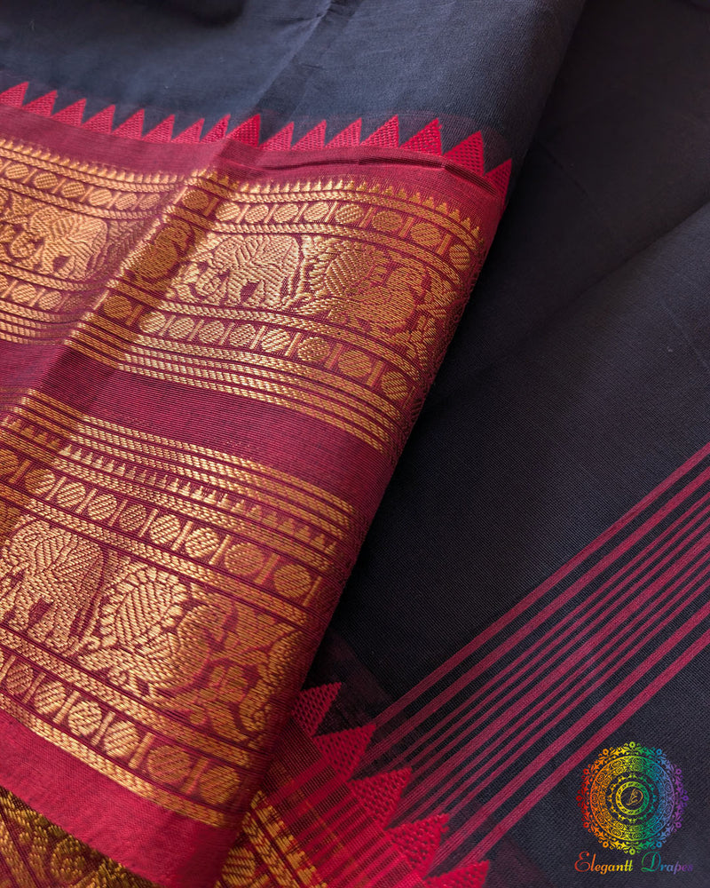 Black Kanchi cotton saree border close up highlighting red woven detailing and texture