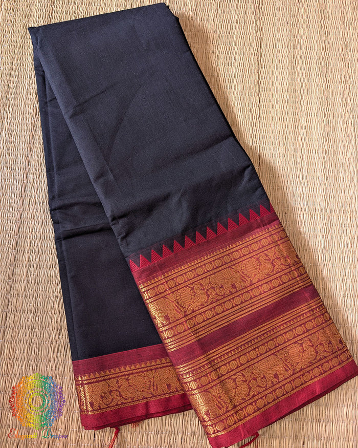 Folded black red pure Kanchi cotton saree showing red border detail