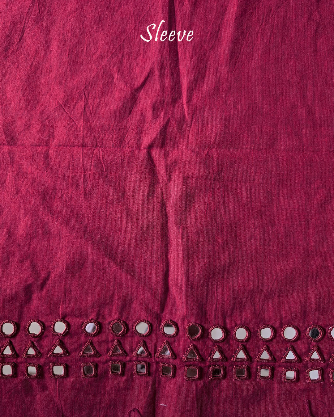 Sleeve detail of the Red Kala Cotton Kutch Mirror Handwork blouse piece, highlighting the traditional embroidery, real mirror embellishments and rich red Kala Cotton fabric.