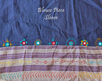 Matching blouse sleeve with handcrafted Lambani embroidery showcasing traditional artisan detailing