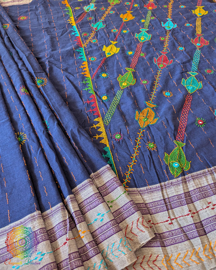Indigo Blue Ilkal cotton fabric showcasing woven texture, Lambani bootas, and fine embroidery