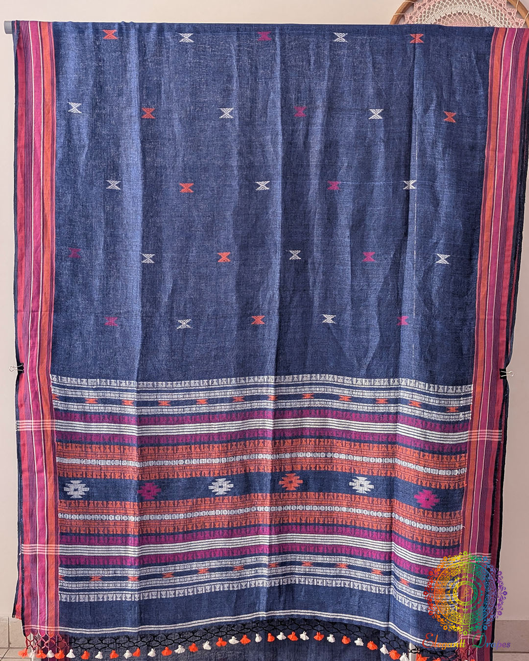 Full blue linen saree laid open showing Bhujodi weave pattern and layout