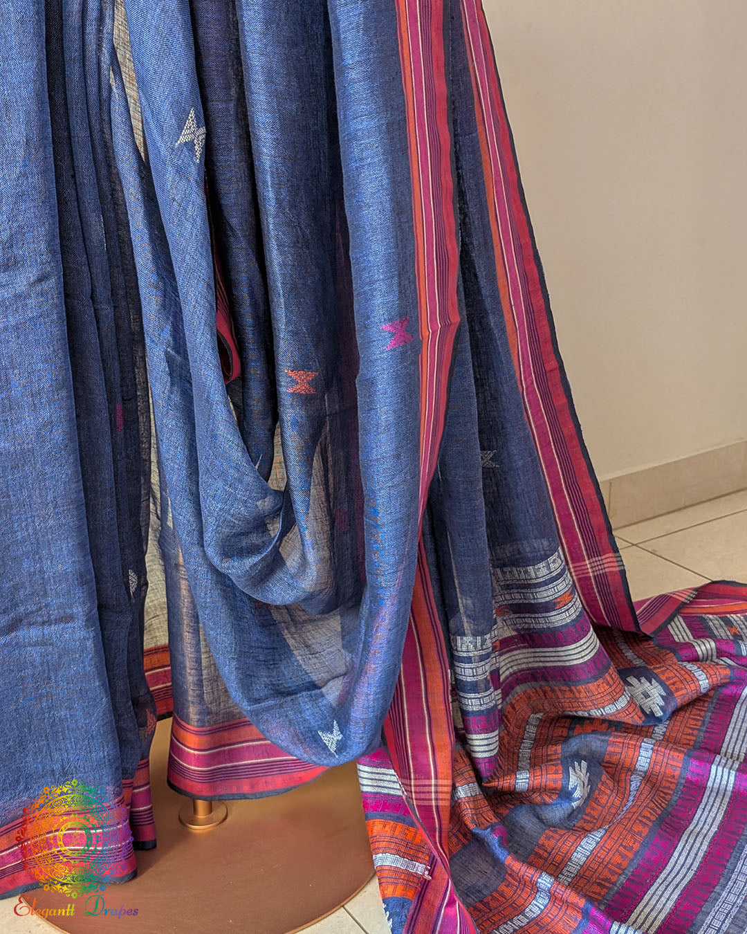 Pleats detail of blue linen saree showing texture and structured drape