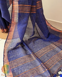 Sequin detail close up on navy blue linen saree highlighting subtle shine