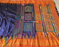 Detailed view of handcrafted embroidery on orange palla of Ilkal silk saree