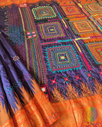 Blue pure Ilkal silk saree laid open showing orange palla and border