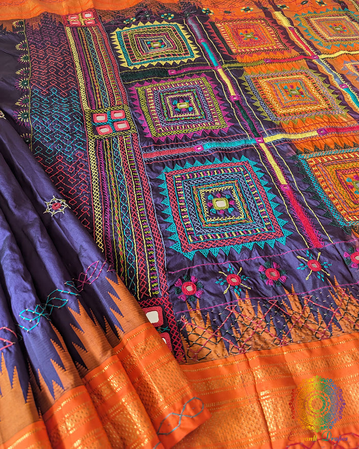 Blue pure Ilkal silk saree laid open showing orange palla and border