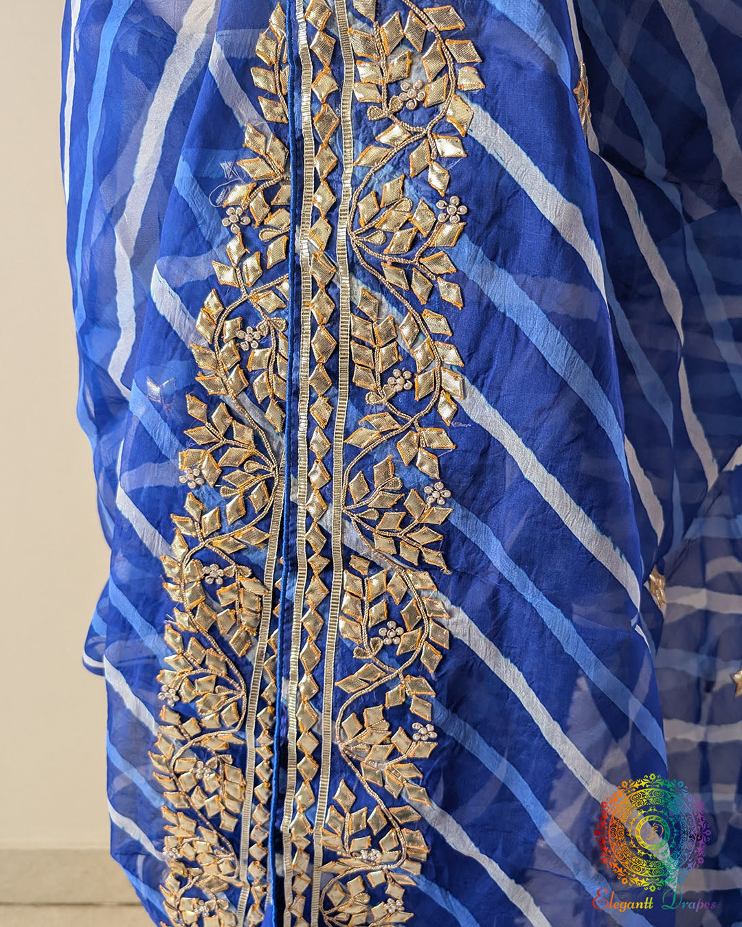 Royal Blue Organza Saree – Detailed view of handcrafted Kachha Gota embellishment adding traditional shimmer to the rich blue Leheria patterned body