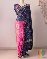 Navy blue gaji silk Bandhani saree showcasing elegant drape, baby pink palla, and Nakshi border