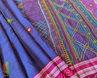 Detailed view of handcrafted Lambani embroidery on the blue Ilkal cotton saree