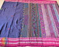 Close-up of traditional Lambani embroidered bootas across the blue Ilkal cotton saree