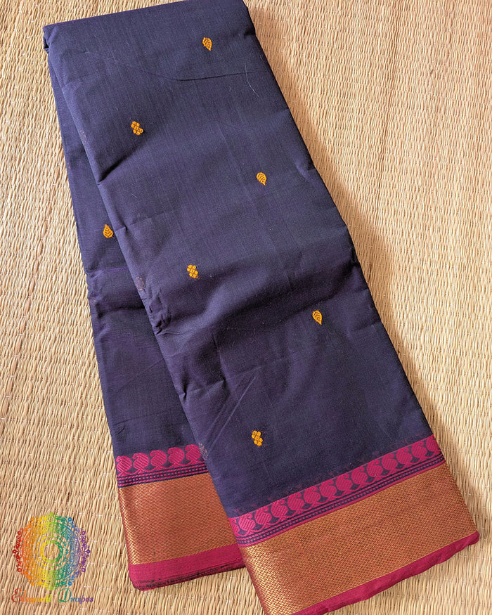 Folded blue pure Kanchi cotton saree showing pink border detail