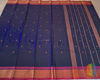 Full blue Kanchi cotton saree laid open showcasing pink border and overall design