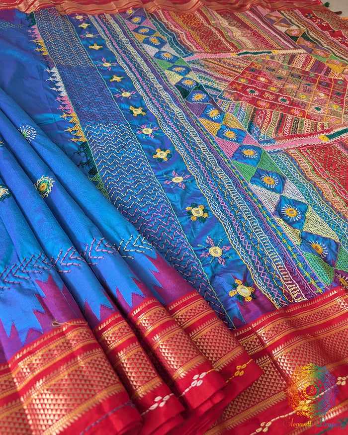 Blue Pure Ilkal Silk Saree with Sindur Lambani Handwork shown in a full open view, highlighting the blue silk body with a contrasting red palla and border.