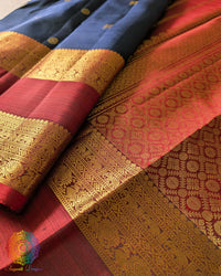 Red palla close up showcasing intricate zari weaving on navy blue Kanjivaram silk saree
