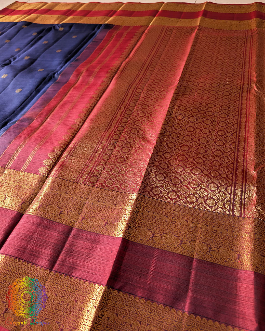 Red palla close up showcasing intricate zari weaving on navy blue Kanjivaram silk saree