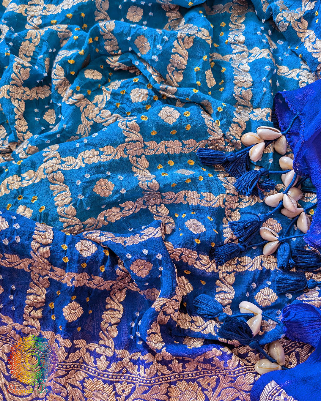Close-up of traditional kodi tassels, zari border, and Bandhani motifs on blue shaded Banarasi georgette Gharchola Bandhani dupatta