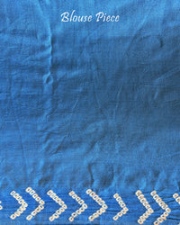 Matching blouse piece in blue shaded gaji silk fabric with bandhani detailing