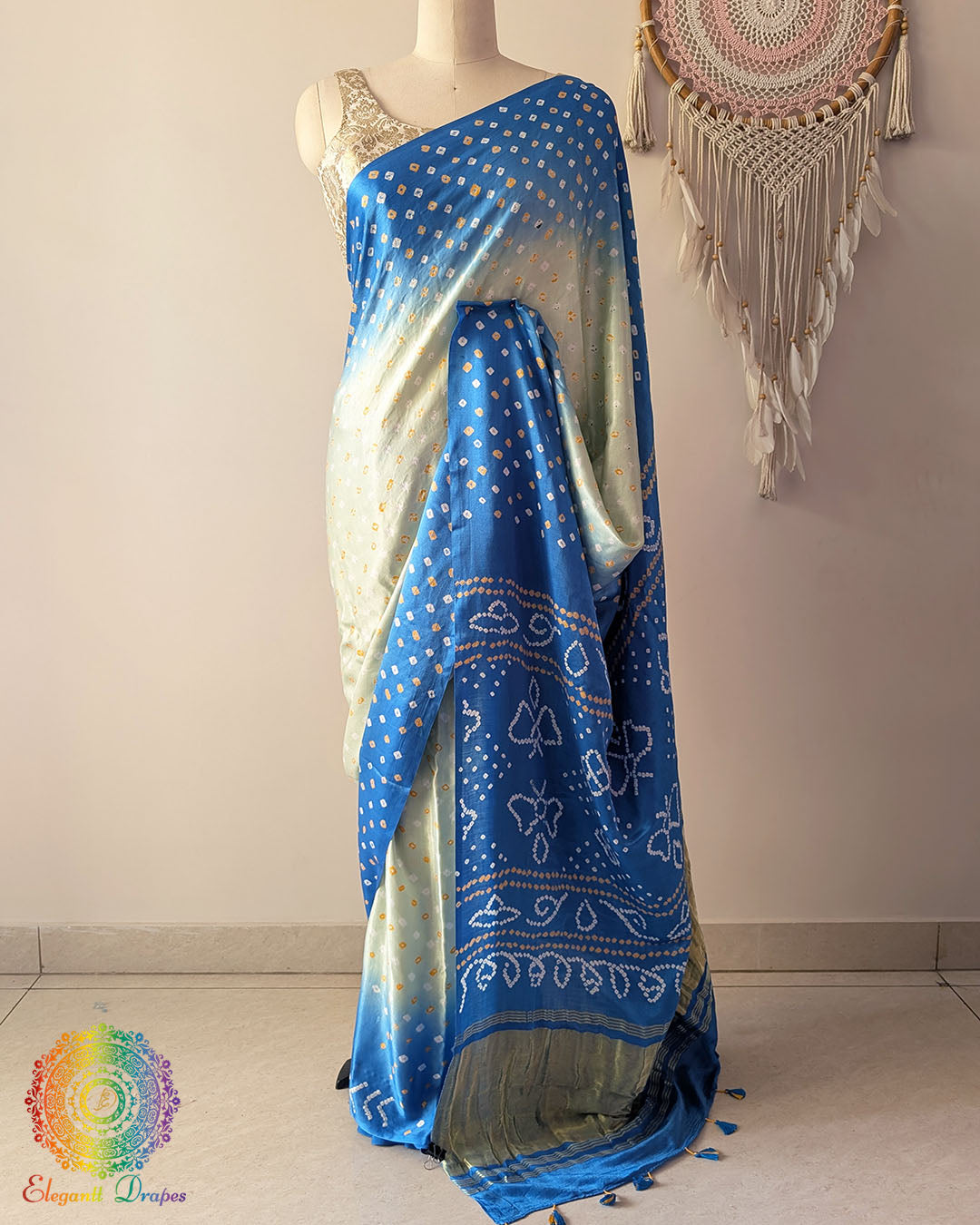 Blue shaded pure gaji silk saree with all-over bandhani dots on mannequin showing full drape