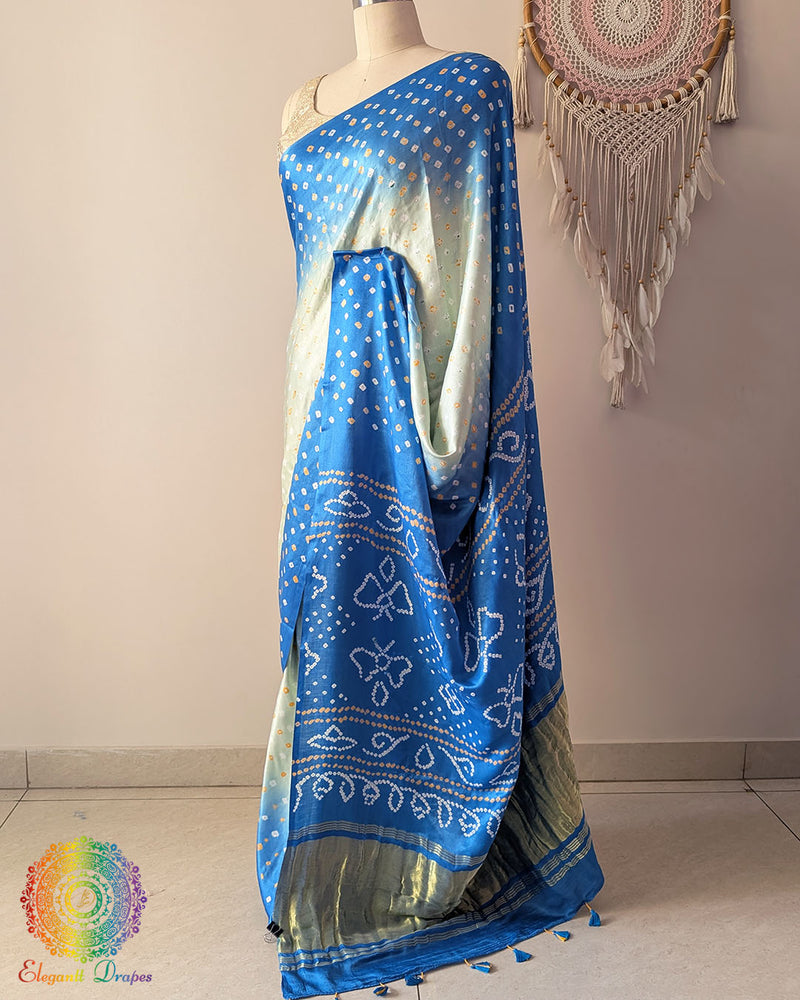 Side angle view of blue shaded bandhani saree highlighting fluid silk drape