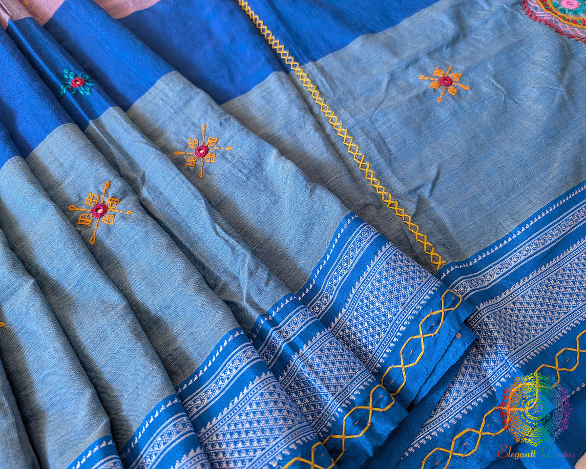 Close-up of intricate Lambani hand embroidery on the richly embellished palla