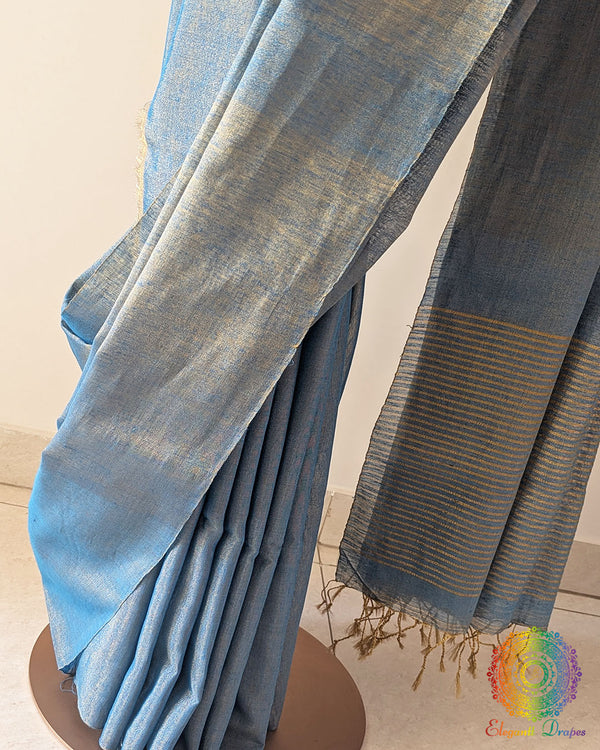 Detailed view of woven zari stripes on the palla of blue linen tissue saree