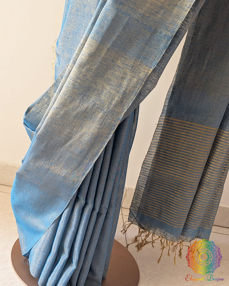 Detailed view of woven zari stripes on the palla of blue linen tissue saree