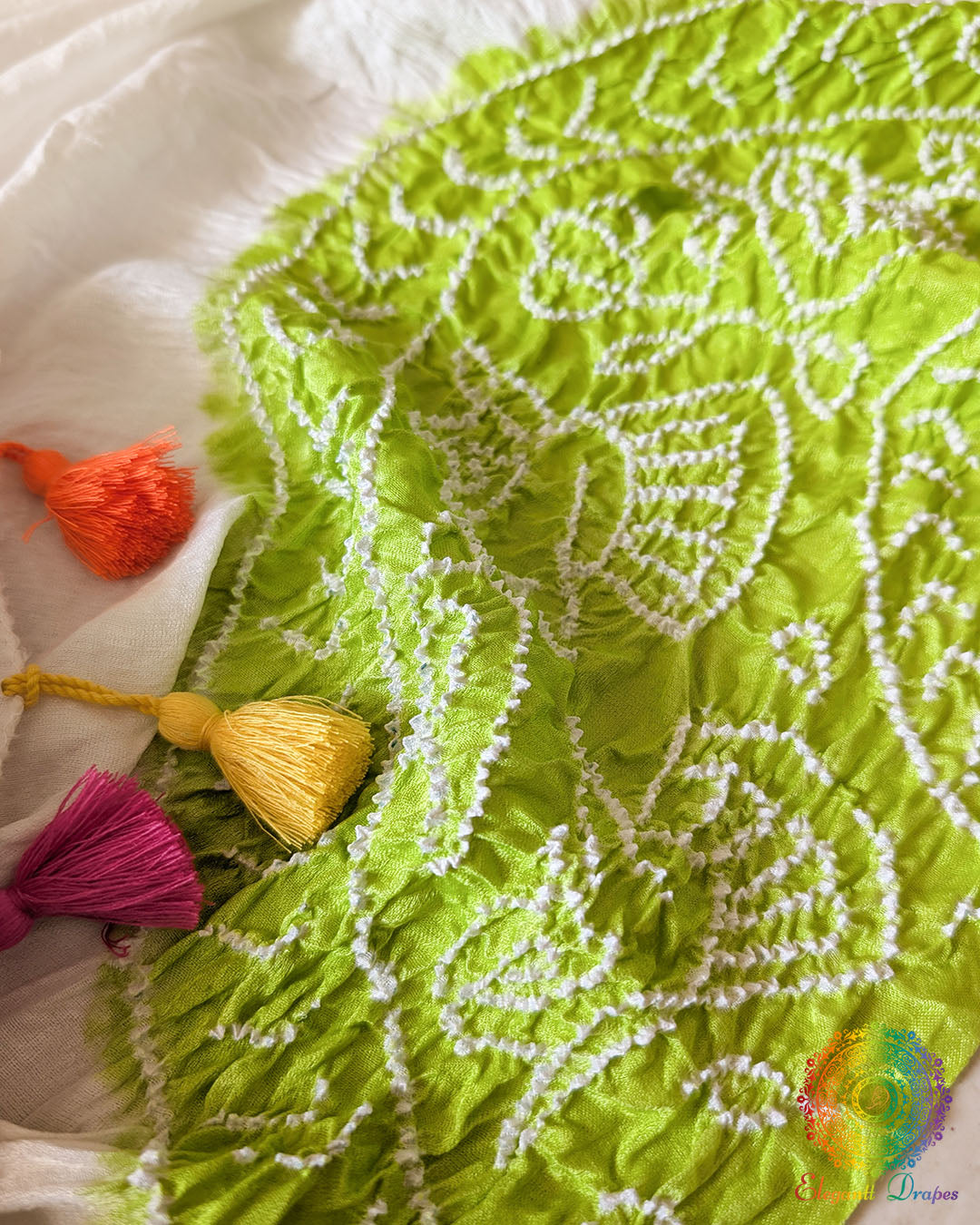 Close-up of the White Gajji Silk Bandhani Dupatta featuring blue, yellow and green tie-dye patterns, showcasing the intricate dotted details and multicolour design.
